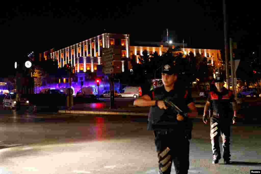 Police officers stand guard near the Turkish military headquarters in Ankara, Turkey, July 15, 2016.