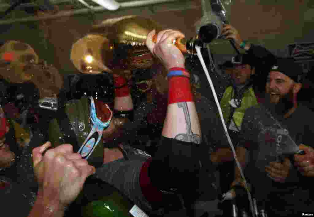 Oct 30, 2013; Boston, MA, USA; Boston Red Sox left fielder Jonny Gomes (right) celebrates with teammates after winning game six of the MLB baseball World Series at Fenway Park. Red Sox won 6-1. Mandatory Credit: Greg M. Cooper-USA TODAY Sports - RTX14US1