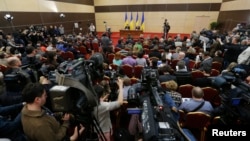 FILE - Journalists listen to ousted Ukrainian President Viktor Yanukovich during a news conference in the southern Russian city of Rostov-on-Don, Feb. 28, 2014.
