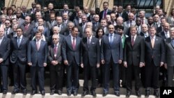 French Foreign Minister Laurent Fabius, center, stands with representatives of other Friends of the Syrian People of Syria at their Paris meeting, Friday, July 6. 