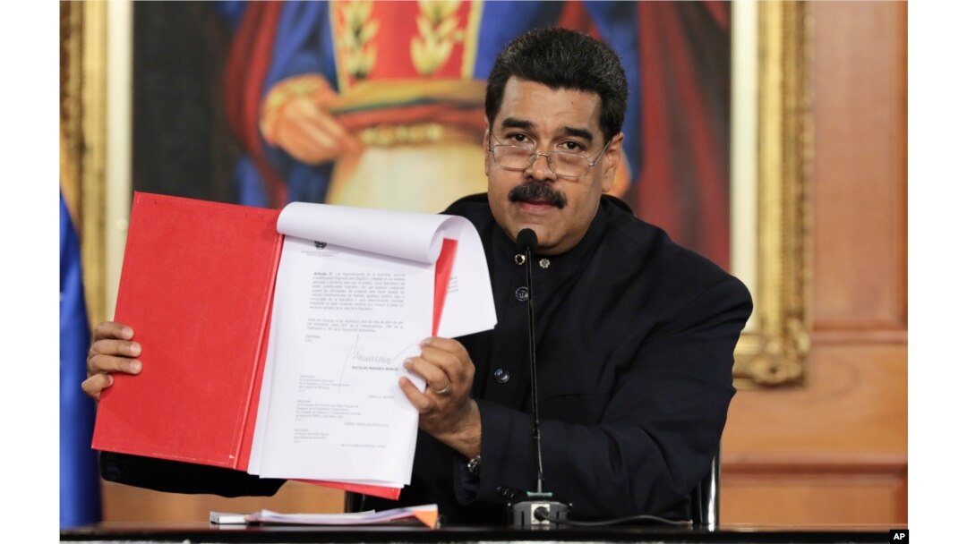 Venezuela's President Nicolas Maduro holds a document as he speaks during a ceremony at Miraflores Palace in Caracas, May 1, 2017.