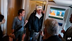 President Donald Trump talks with reporters aboard Air Force One, en route to Washington, Sept. 14, 2017.