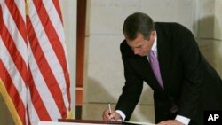 House Speaker John Boehner signs a condolence and well wishes book for the victims of the mass shooting in Arizona inside the U.S. Capitol Building on Capitol Hill, 12 Jan 2011