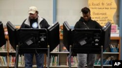 Rich Baranowski, left, and Tracy Hardy vote in Ferguson's municipal election Tuesday, April 7, 2015.