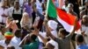 Sudanese demonstrators celebrate after Defense Minister Awad Ibn Auf stepped down as head of the country's transitional ruling military council, as protesters demanded quicker political change, near the Defense Ministry in Khartoum, Sudan, April 13, 2019.