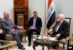 U.S. Secretary of State Rex Tillerson, left, listens as Iraqi President Fuad Masum speaks during their meeting, Oct. 23, 2017, in Baghdad, Iraq.
