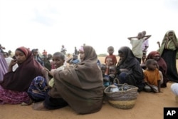Women and children fleeing the war in Somalia queue to register at Dadaab