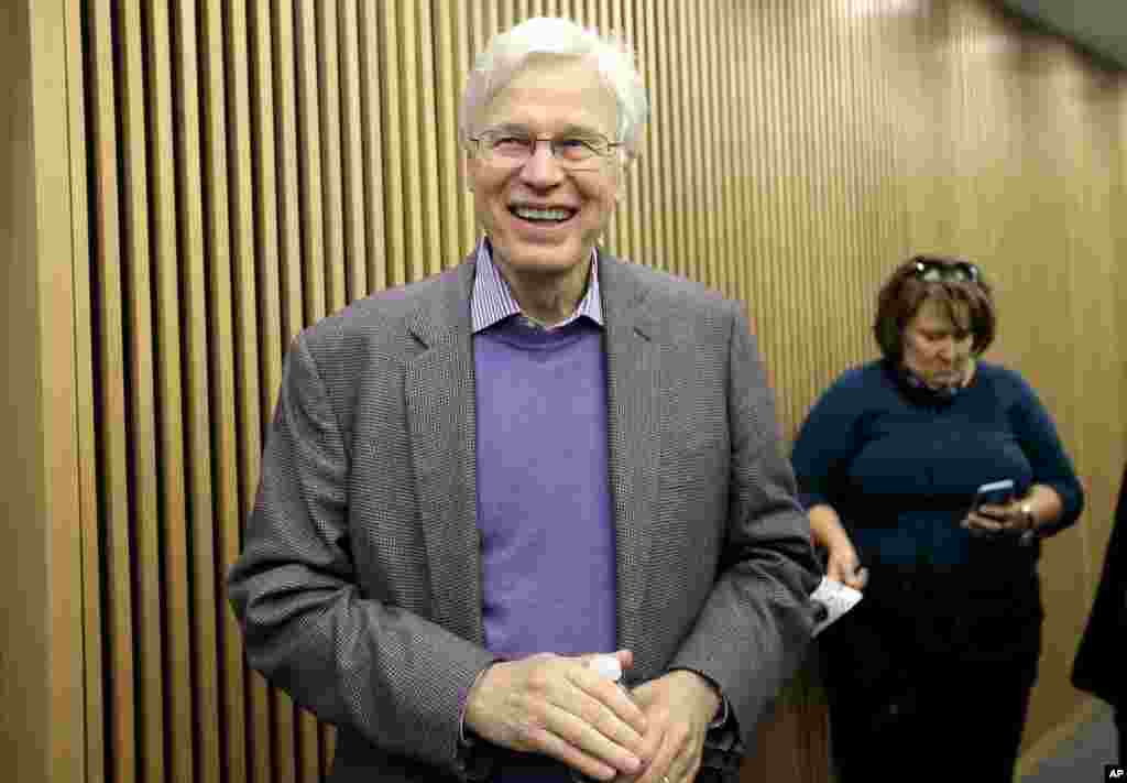 Finnish Professor Bengt Holmstrom of the Massachusetts Institute of Technology smiles as he departs a news conference after speaking to members of the media, Oct. 10, 2016, on the campus of MIT in Cambridge, Mass. 