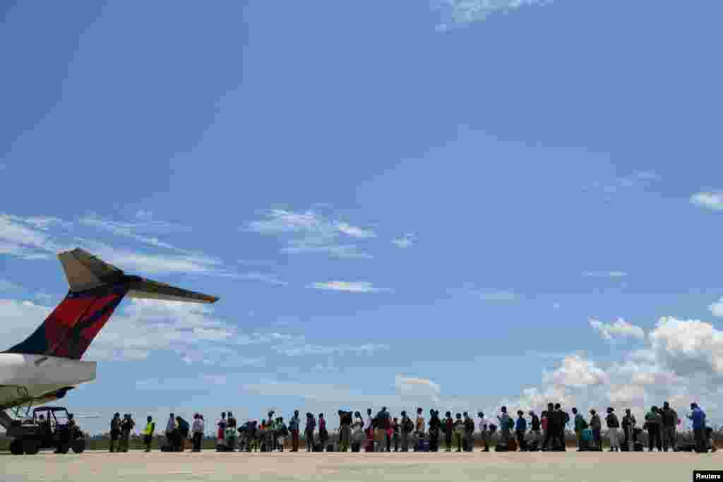 Abaco residents are evacuated from the island at the airport in the wake of Hurricane Dorian in Marsh Harbour, Great Abaco, Bahamas, Sept. 8, 2019.