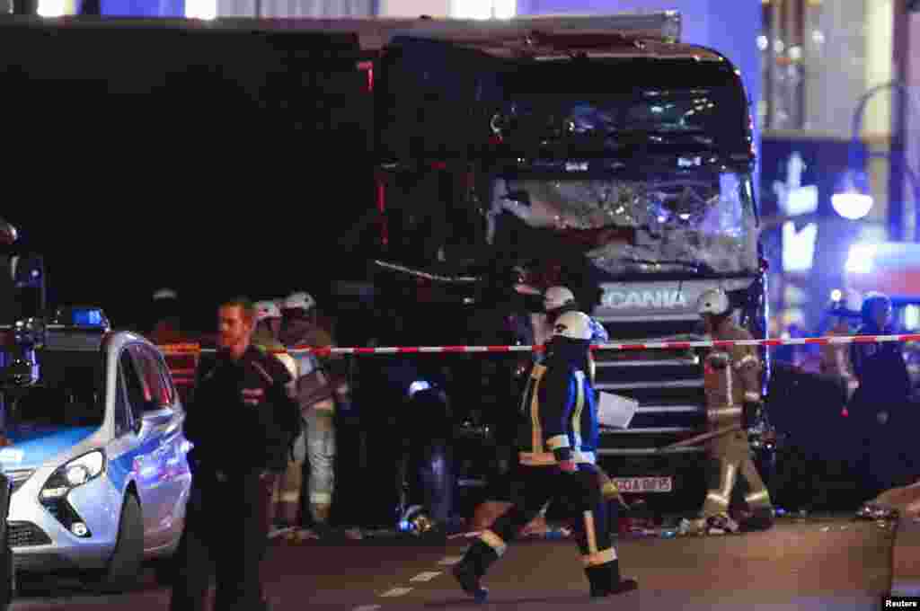 Seorang petugas pemadam kebakaran berjalan di depan sebuah truk di pasar Natal di alun-alun Breitscheidplatz dekat daerah Kurfuerstendamm di bagian barat Berlin, Jerman (19/12). (Reuters/Fabrizio Bensch)