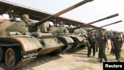 FILE PHOTO - Cambodia's Deputy Prime Minister and Defence Minister Tea Banh (2nd R) inspect tanks inside the Army Institute after a graduation ceremony at Army Institute in Kampong Speu province on March 12, 2015. (REUTERS/Samrang Pring)