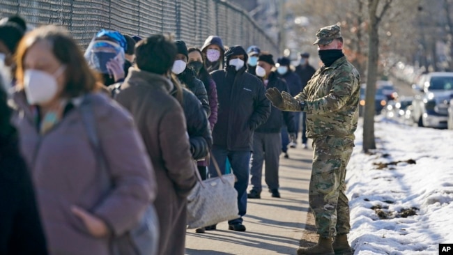 People wait in line to get vaccinated at a mass COVID-19 vaccination site in the Queens borough of New York, Wednesday, Feb. 24, 2021. (AP)