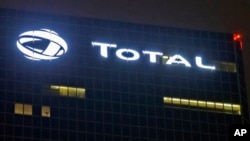 FILE - In this file photo taken on Oct.12, 2016, the logo of French oil giant Total SA is pictured at company headquarters in La Defense business district, outside Paris. 