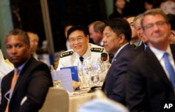 China's Joint Staff Department Deputy Chief Adm. Sun Jianguo, center, attends the Opening Dinner of the 15th International Institute for Strategic Studies Shangri-la Dialogue, or IISS, Asia Security Summit, in Singapore, June 3, 2016. U.S. Defense Secretary Ash Carter is at right.