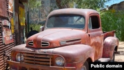 A very old red Ford pick-up truck. Some might call it "ugly" and that would be an example of an opinion adjective.