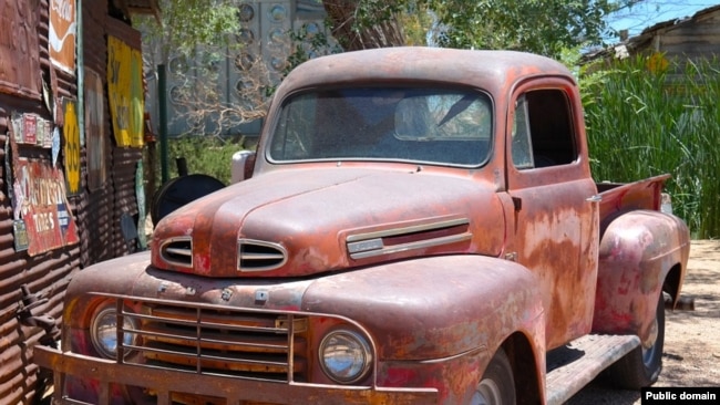 A very old red Ford pick-up truck. Some might call it "ugly" and that would be an example of an opinion adjective.