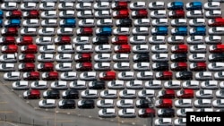 FILE - New Ford vehicles are seen at a parking lot of the Ford factory in Sao Bernardo do Campo, Brazil, Feb. 12, 2015. 
