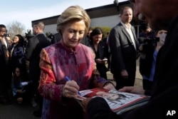 Democratic presidential candidate Hillary Clinton signs autographs after voting at the Grafflin Elementary School in Chappaqua, New York, April 19, 2016.