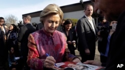 Democratic presidential candidate Hillary Clinton signs autographs after voting at the Grafflin Elementary School in Chappaqua, New York, April 19, 2016.