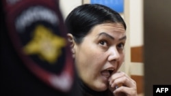 Gyulchekhra Bobokulova, a nanny suspected of killing a young girl in her care, reacts inside a defendants' cage during a court hearing in Moscow, March 2, 2016. Prosecutors argue Bobokulova is mentally unstable.