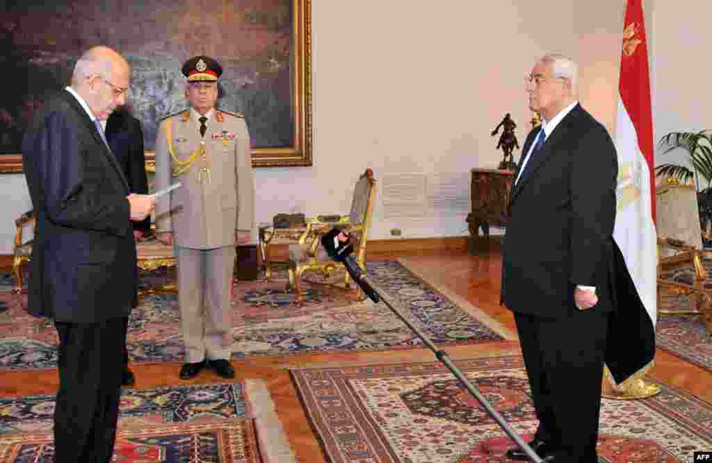 This handout photo shows Mohamed ElBaradei being sworn in as Egypt's interim vice president for foreign relations, in front of Egypt's interim president Adly Mansour, Cairo, July 14, 2013.