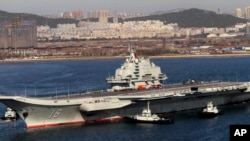 Chinese aircraft carrier Liaoning cruises back to port after its first navy sea trial in Dalian, northeastern China, Oct. 30, 2012.