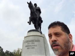 Michel-Antoine Goitia-Nicolas stands next to an equestrian statue of P.G.T. Beauregard, a Louisiana-born Confederate general, in New Orleans, March 16, 2016.
