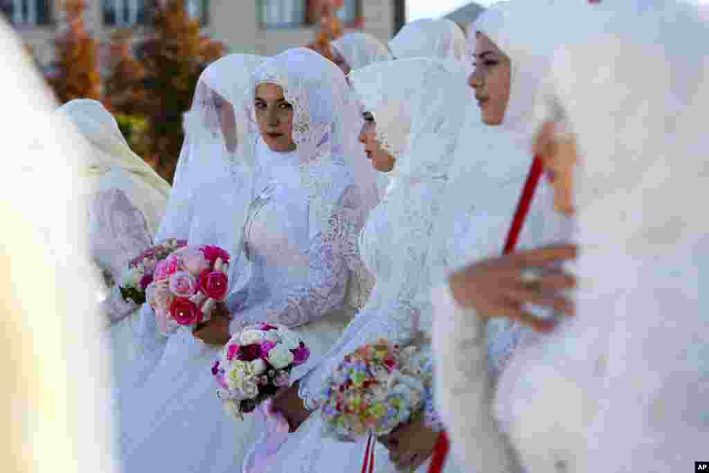 Newly married Chechen couples attend the City Day celebration in Grozny, Russia.