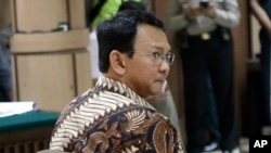 FILE - Jakarta Governor Basuki Tjahaja Purnama, popularly known as "Ahok", sits on the defendant's chair during his trial at the North Jakarta District Court in Jakarta, Indonesia.