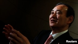 FILE - Japan's Chief Cabinet Secretary Yoshihide Suga speaks during an interview with Reuters in Tokyo.