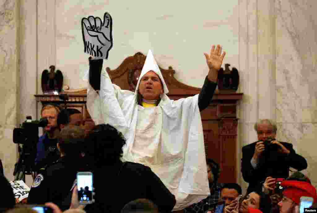 A protester dressed as a Klansman disrupts the start of a Senate Judiciary Committee confirmation hearing for U.S. Attorney General-nominee Senator Jeff Sessions on Capitol Hill in Washington.