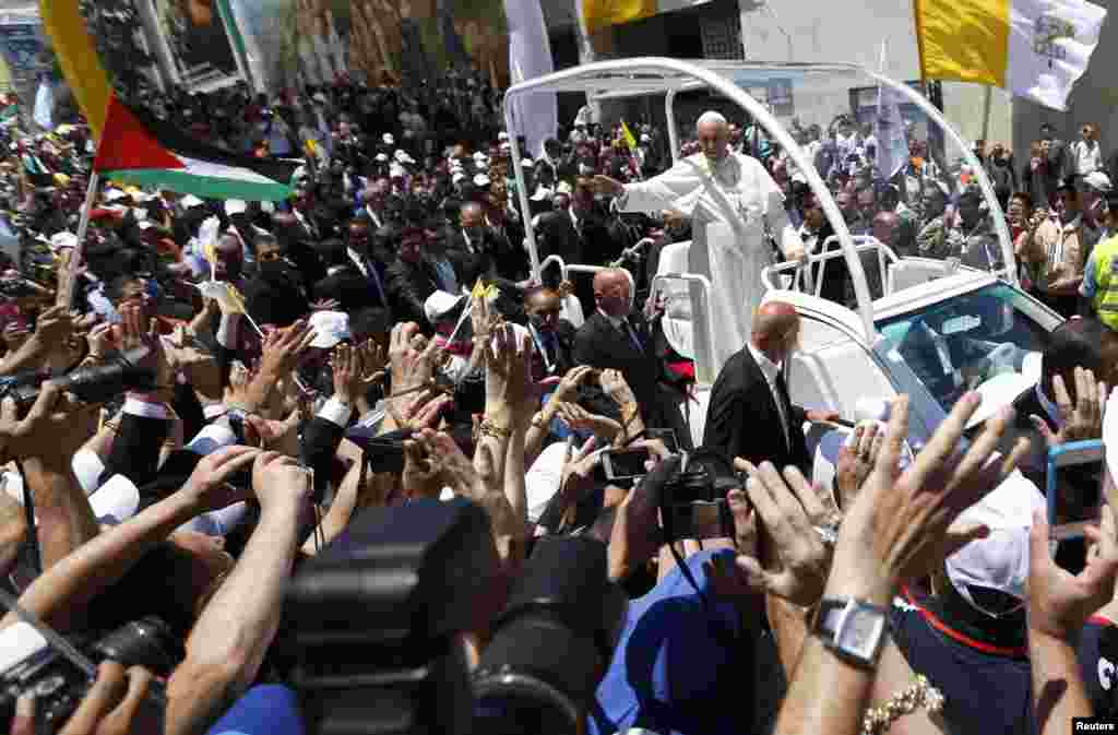 Pope Francis waves to the crowd at Manger Square in the West Bank town of Bethlehem.