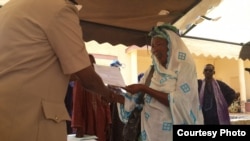 A Senegalese woman receives her land title. MCC and Senegal have worked together to help resolve complex land tenure issues that impede economic growth.