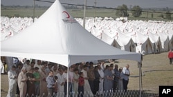 Syrian refugees pray in a camp in Boynuyogun, Turkey, near the Syrian border, June 16, 2011