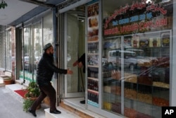 A man enters a shop in the Uighur immigrant neighborhood of Zeytinburnu, Turkey, Dec. 14, 2017.