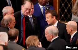 French President Emmanuel Macron greets members of Congress after a joint meeting of Congress in the House chamber of the U.S. Capitol in Washington, April 25, 2018.