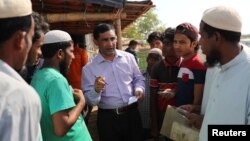 FILE - Rohingya activist Mohib Ullah speaks with Rohingya refugees in Cox's Bazar, Bangladesh, April 7, 2019. Unidentified gunmen shot and killed Ullah at Kutupalong refugee camp, also in Cox's Bazar, Sept. 29, 2021.