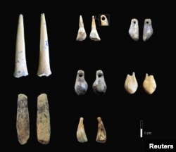 Bone points and pierced teeth, sampled for radiocarbon dating from the early Upper Paleolithic layers of Denisova Cave in Siberia, Russia, are shown in this photo provided Jan. 30, 2019.
