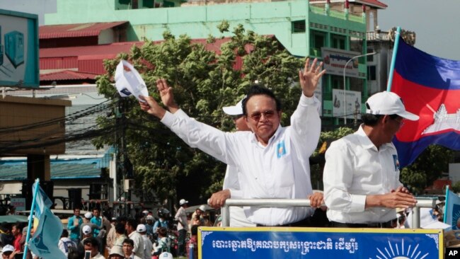 In this June 2, 2017, file photo, opposition party Cambodia National Rescue Party (CNRP) leader Kem Sokha greets his supporters at a rally in Phnom Penh. (AP Photo/Heng Sinith, File)