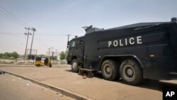 FILE - A police truck with water cannons stands guard outside the election commission offices in Kano, northern Nigeria, March 29, 2015. 