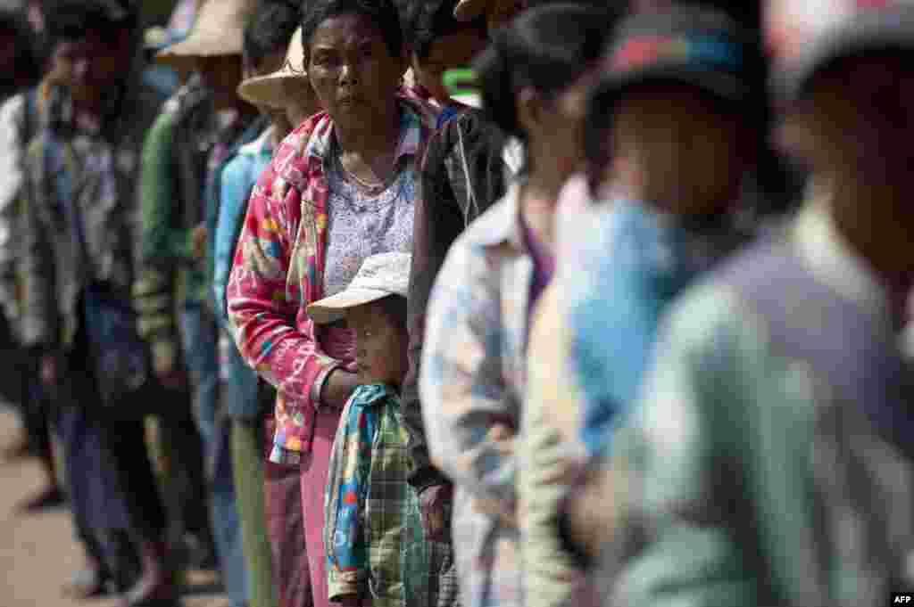 Residents who fled from conflict areas near the Myanmar-Chinese border arrive at a temporary refugee camp at a monastery in Lashio, northern Myanmar. Myanmar&#39;s army continued an offensive to flush out rebels from areas around a flashpoint town on the northeastern border with China, state media said, in 11 days of fighting that have displaced tens of thousands of people.