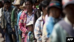 Residents who fled from conflict areas near the Myanmar and Chinese border arrive at a temporary refugee camp at a monastery in Lashio, northern Myanmar, Feb. 20, 2015.