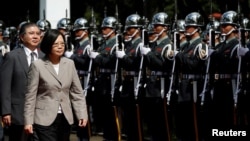 FILE - Taiwanese President Tsai Ing-wen inspects honor guard before a ceremony to mark the 92nd anniversary of the Whampoa Military Academy, in Kaohsiung, southern Taiwan, June 16, 2016.