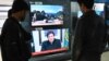 FILE - People watch Pakistani Prime Minister Imran Khan address the nation on TV following the Feb. 14 suicide bombing in Indian-administered Kashmir, in Islamabad, Feb. 19, 2019.