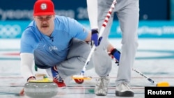 Second Matt Hamilton of the U.S. delivers the stone, Feb. 24, 2018, in the men's curling final against Sweden in Gangneung, South Korea.