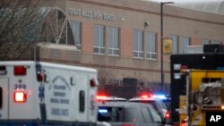 Deputies, federal agents and rescue personnel, converge on Great Mills High School, the scene of a shooting, Tuesday morning, March 20, 2018 in Great Mills, Md.