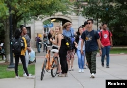 Students walk on campus at the University of Michigan in Ann Arbor, Michigan, Sept. 19, 2018.