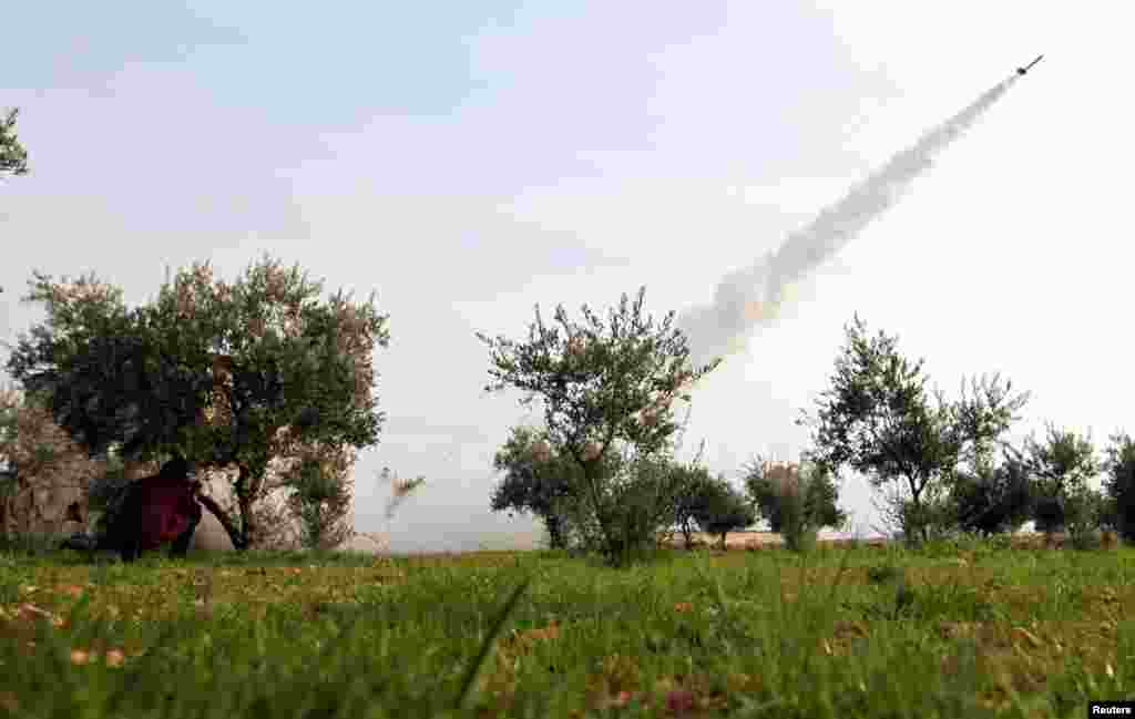 A rocket is launched by Free Syrian Army fighters towards Nairab military airport and the international airport in Aleppo, which are controlled by forces loyal to Syria's President Bashar al-Assad, February 19, 2013.