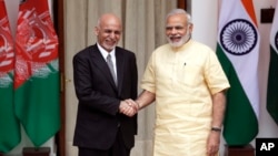 FILE - Indian Prime Minister Narendra Modi, right, shakes hands with Afghan President Ashraf Ghani in New Delhi, India, Sept. 14, 2016.
