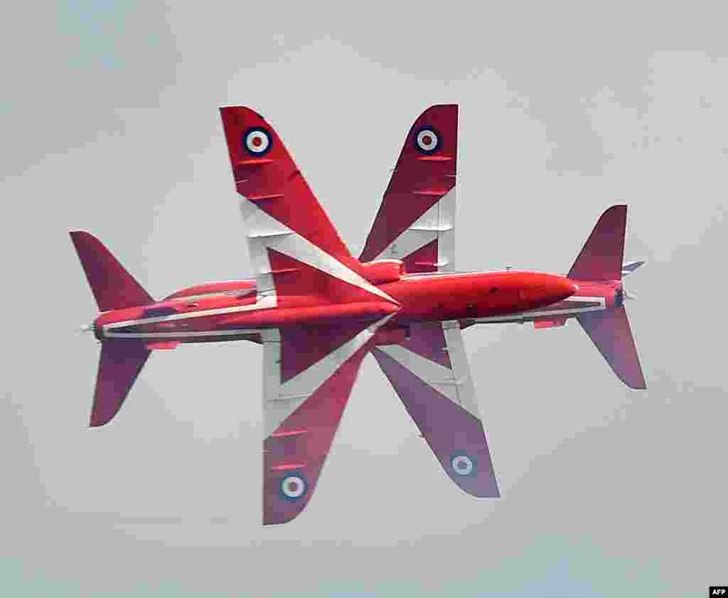 The RAF Aerobatic Team, The Red Arrows perform at the Eastbourne airshow, 'Airbourne' off the coast at Eastbourne, southern England.